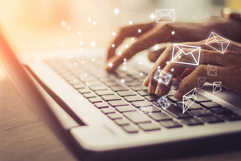 Business woman hand using Laptop pc with email icon