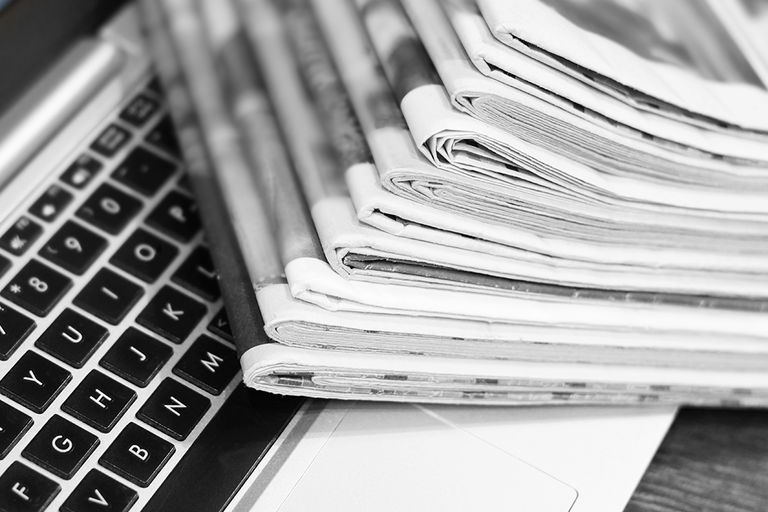 Newspapers and laptop