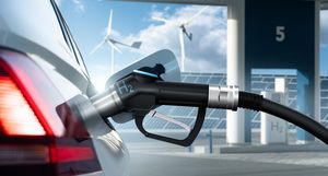 Close up of fuel cell car with connected hydrogen fueling nozzle on a background of H2 filling station using renewable energy